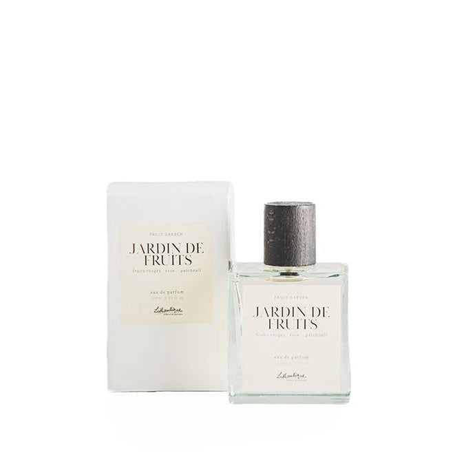 A bottle of Lothantique Eau de Parfum Fruit Garden with its packaging box and cardboard box. The bottle is clear, and the packaging is primarily white and beige with text and branding.