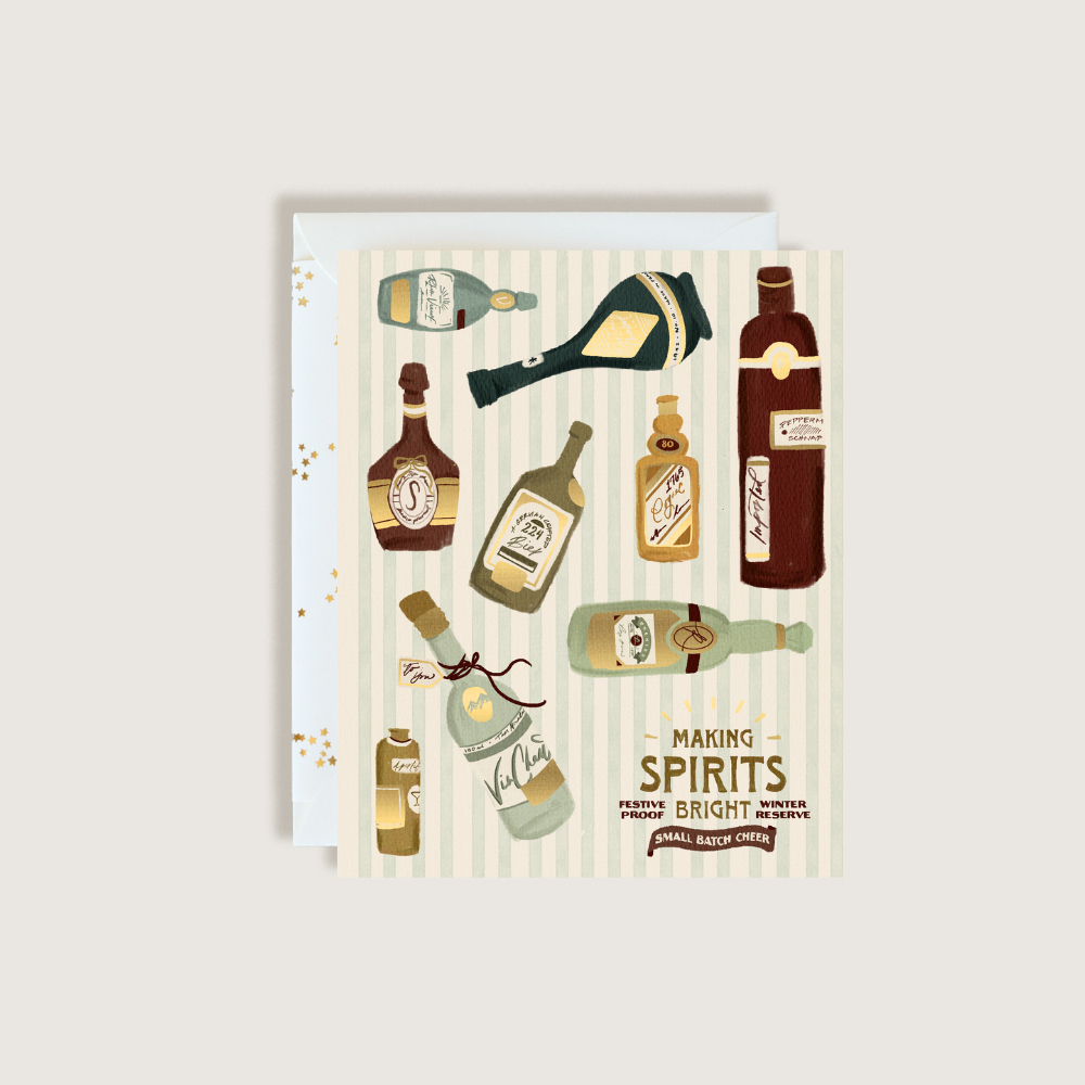 A square greeting card featuring vintage-style illustrations of various liquor and spirit bottles, with the text 'MAKING SPIRITS BRIGHT' on a light striped background. A white envelope is partially visible behind the card.