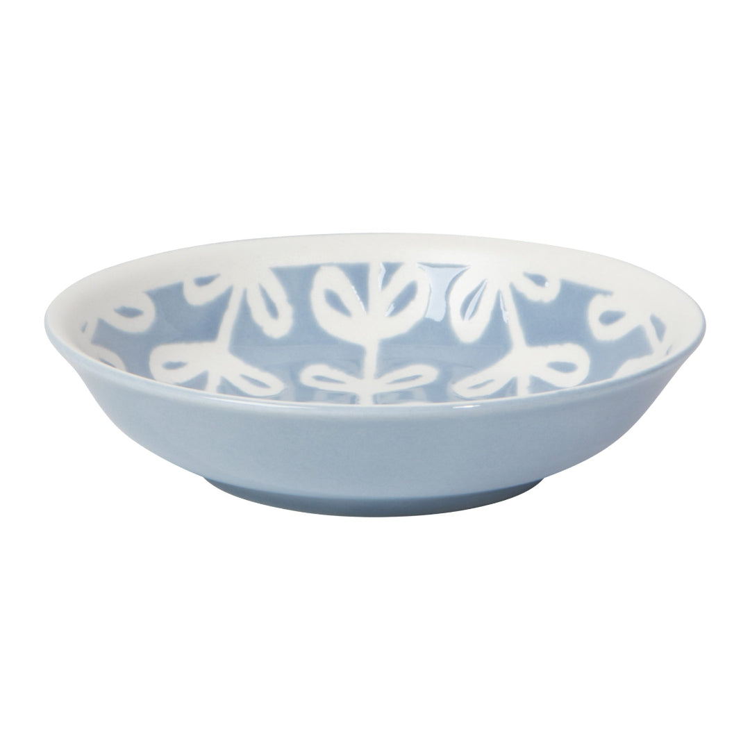 Blue bowl with white floral pattern on a white background