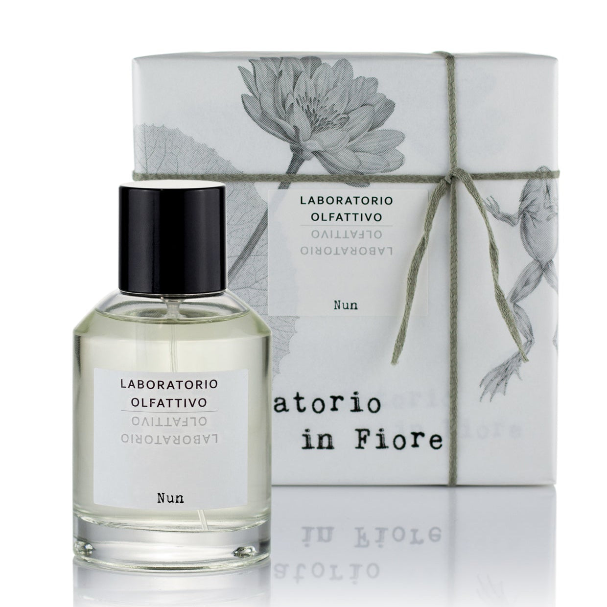 A clear glass bottle with a black cap and a label that reads 'Laboratorio Olfattivo Nun 100ml Eau de Parfum', alongside a grey box with floral graphics.
