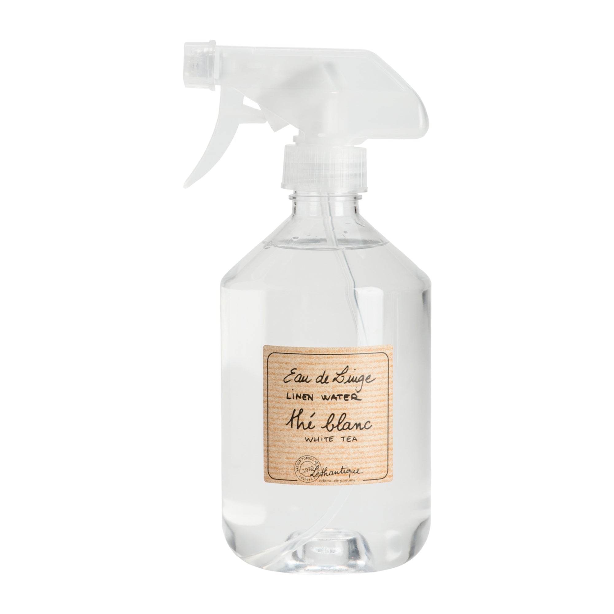 Clear spray bottle with a label on a white background