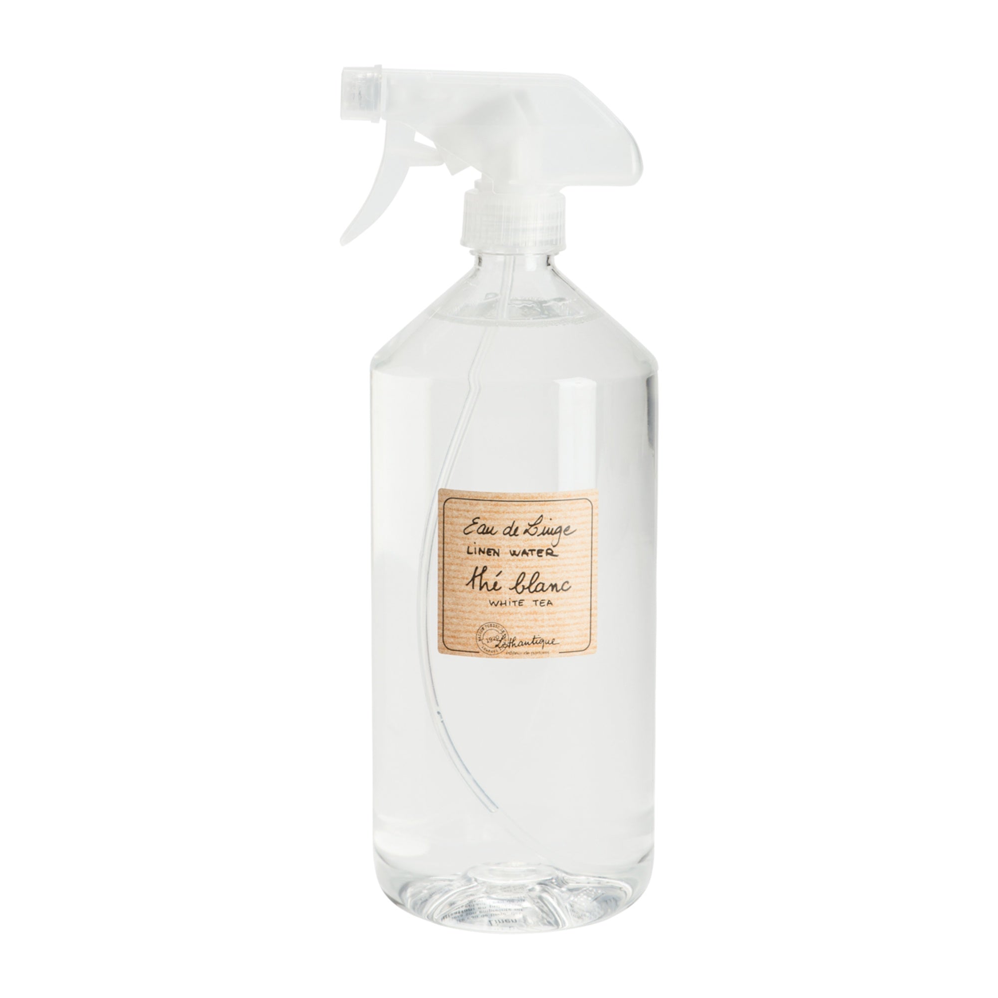 Clear spray bottle with a label on a white background