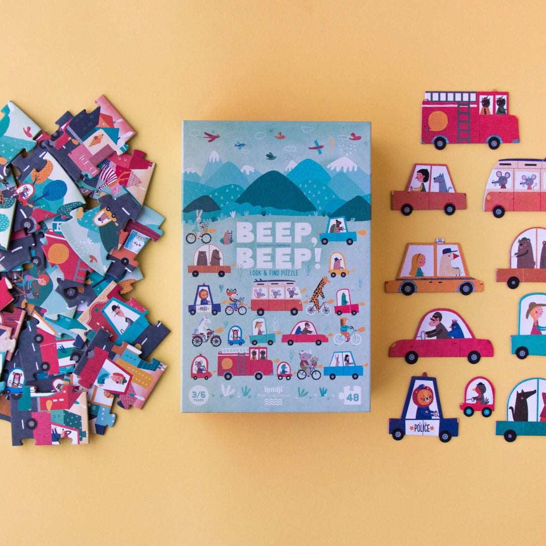 Children's puzzle with 'Beep Beep!' book and pieces on a yellow background