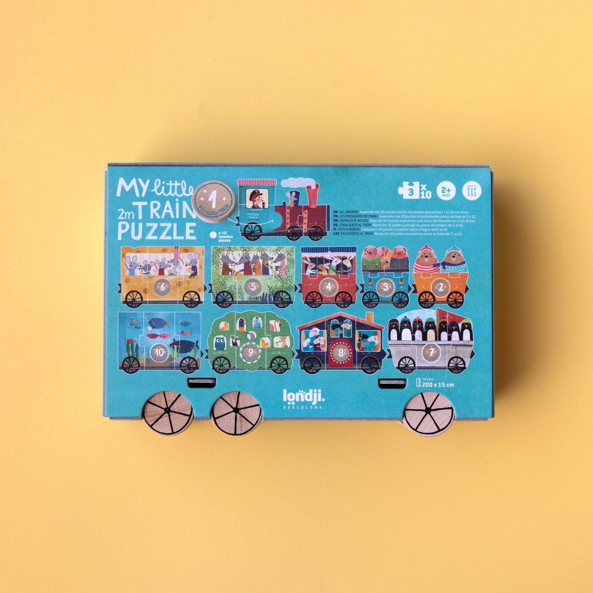 Children's puzzle packaging with train design on a yellow background