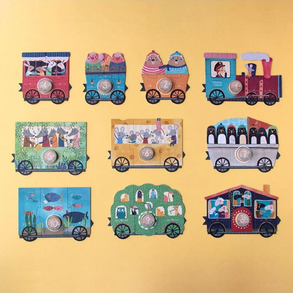 Colorful train-shaped cookies with various designs on a yellow background