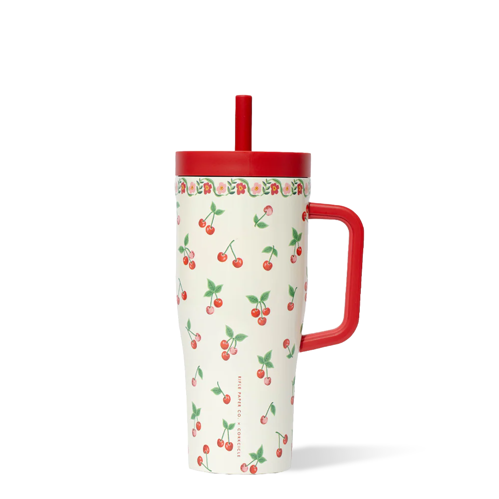 Tumbler with cherry pattern and red handle on a white background