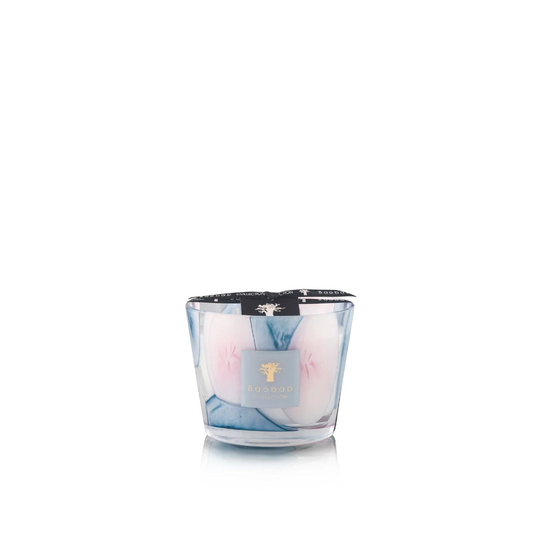 A set of Baobab Riviera Leopolda scented candles in various sizes with transparent glass and pink and blue floral patterns.