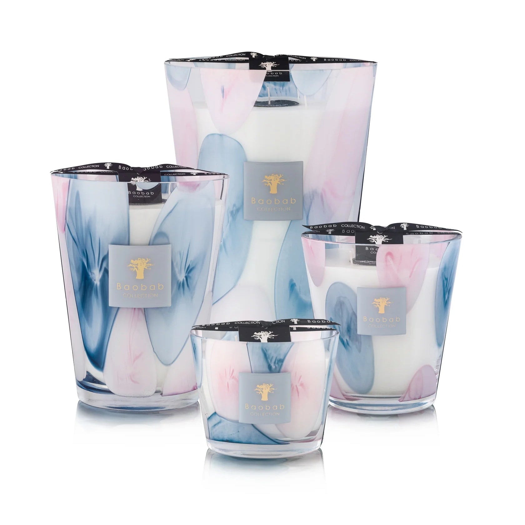 A set of Baobab Riviera Leopolda scented candles in various sizes with transparent glass and pink and blue floral patterns.