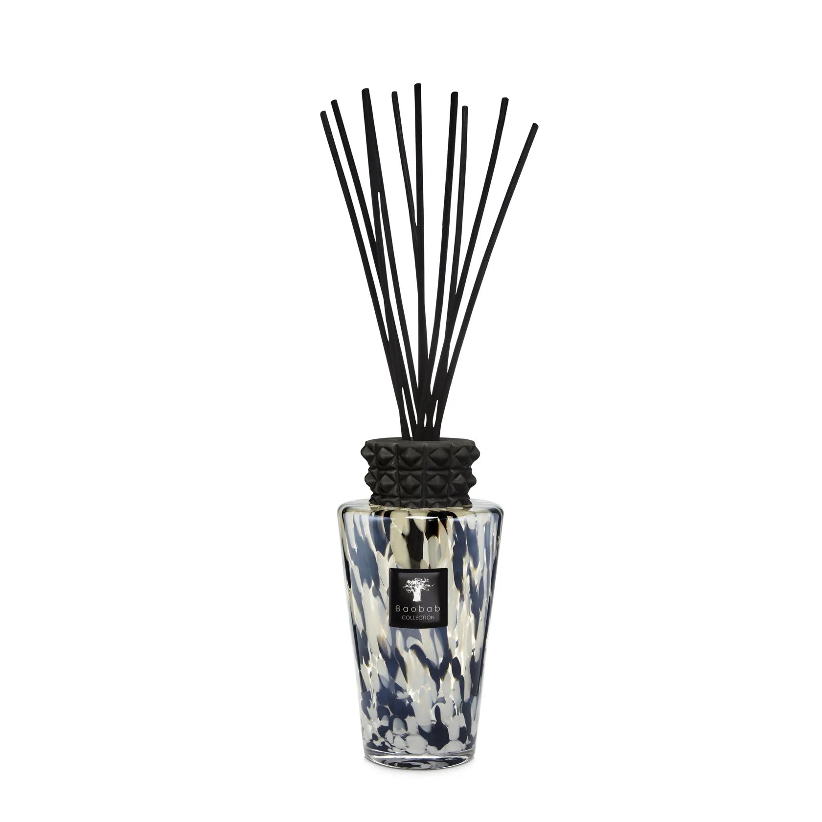 A Pearls Black Diffuser with a floral patterned glass bottle and a decorative cap, equipped with black reeds for fragrance diffusion.