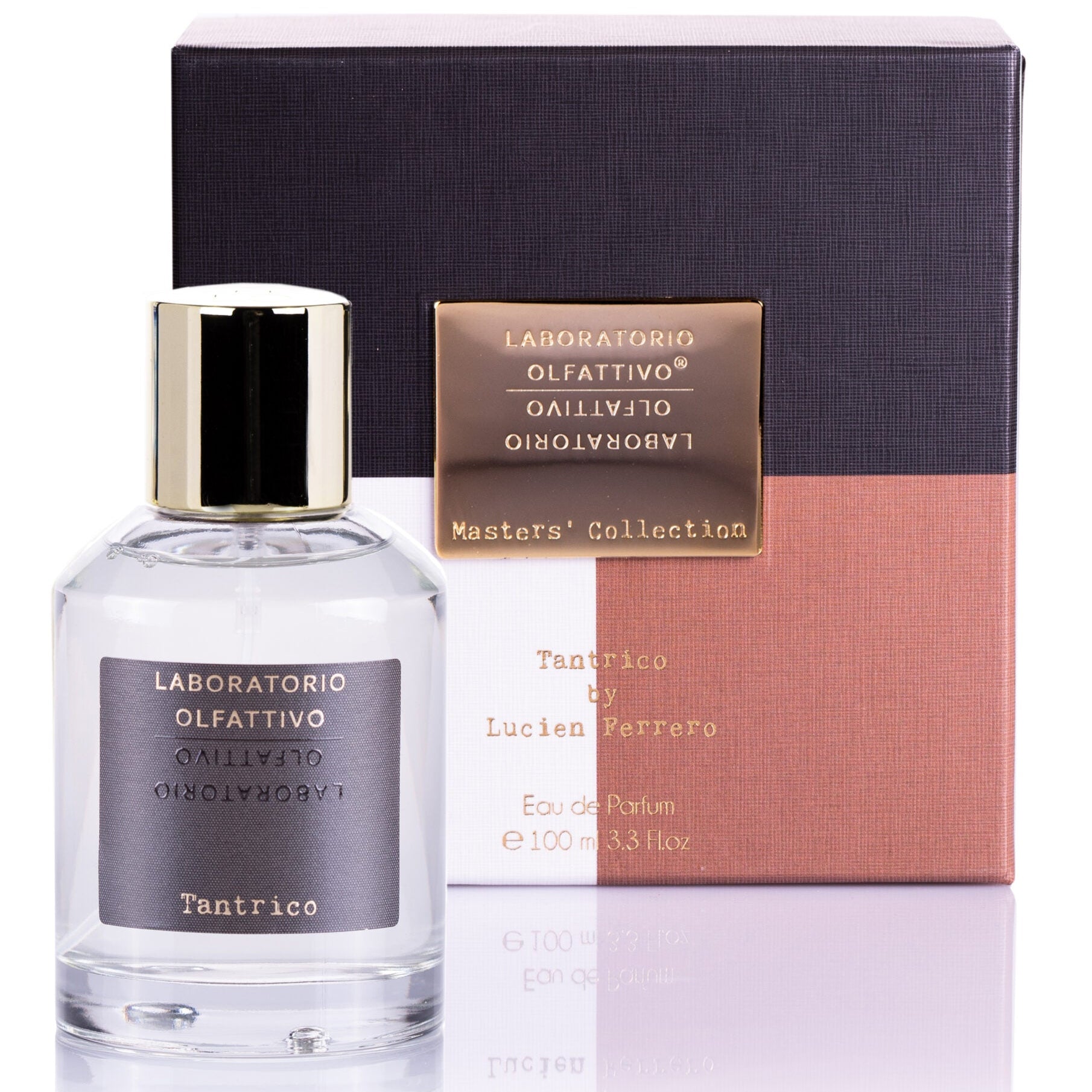 A clear glass bottle of 'Tantrico' eau de parfum with a gold-colored cap, placed next to its purple and pink box packaging that has the brand name and product title visible.