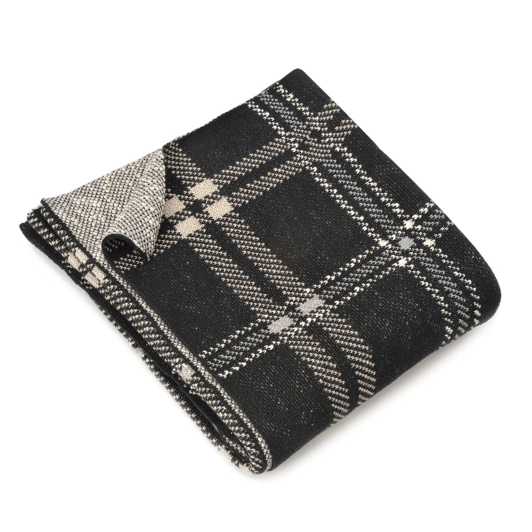 A black and beige plaid throw blanket folded neatly.