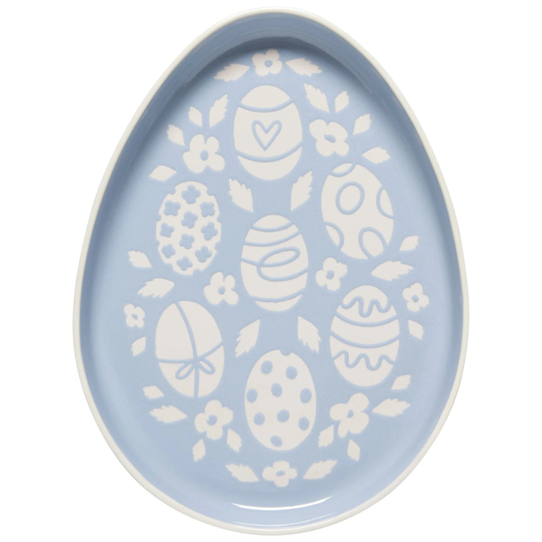 Decorative egg plate and floral patterns on a light blue background