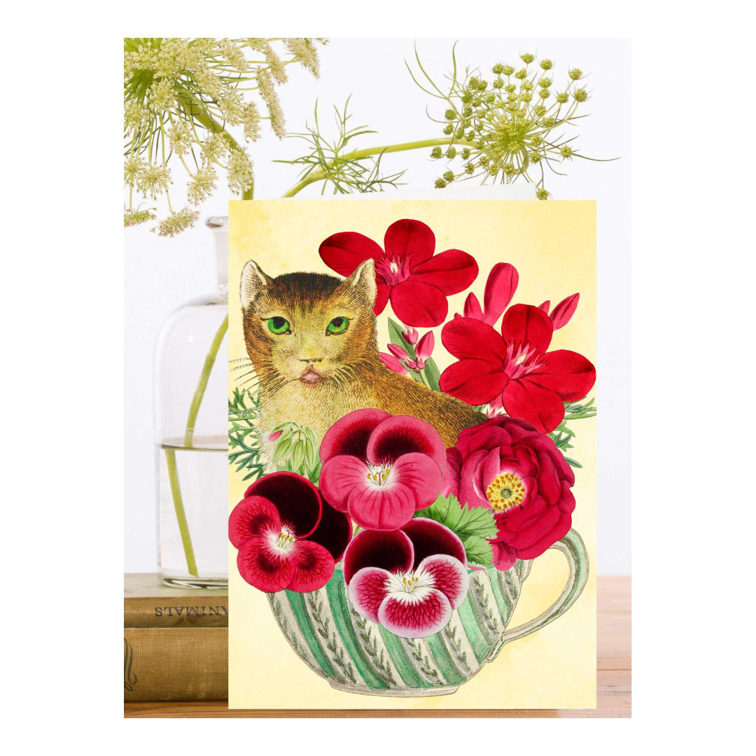 Card with a cat and red flowers on a yellow background