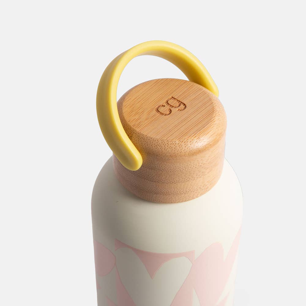 Water bottle with wooden cap and yellow handle on a light gray background
