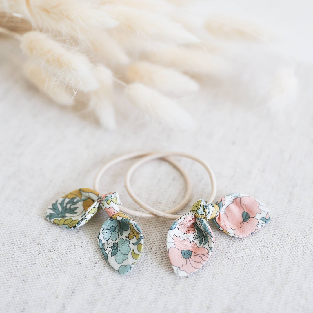 Floral hair elastics on a soft white background