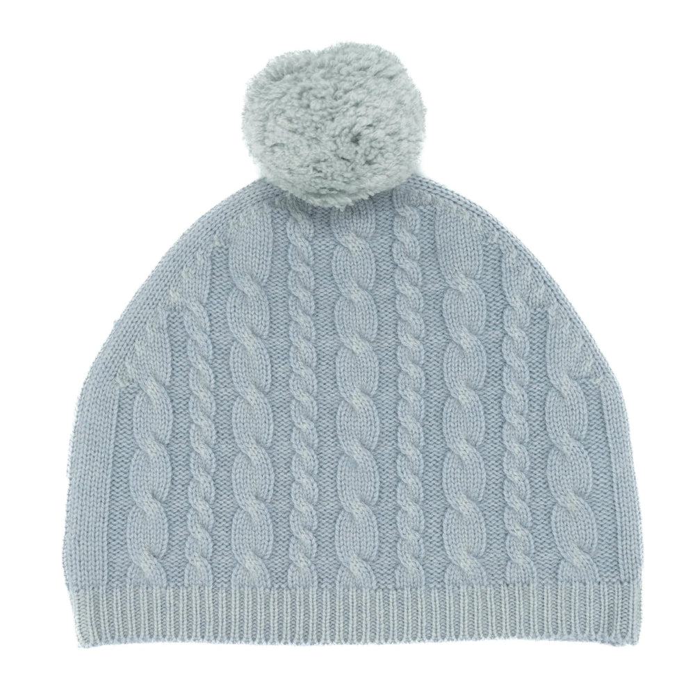 Light blue knitted beanie with a pom-pom on a white background