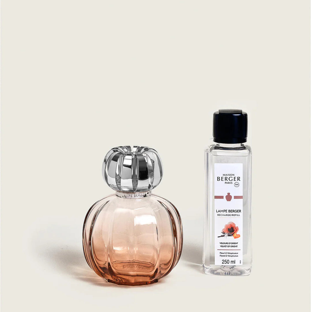 Decorative bottle and Berger lamp oil bottle on a beige background