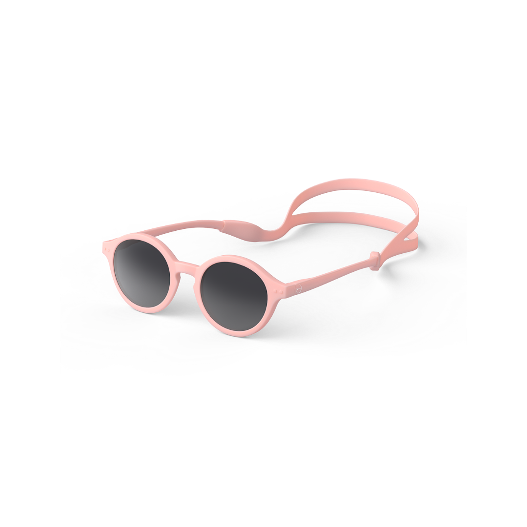 A pair of pastel pink sunglasses designed for kids with a silicone strip for holding.