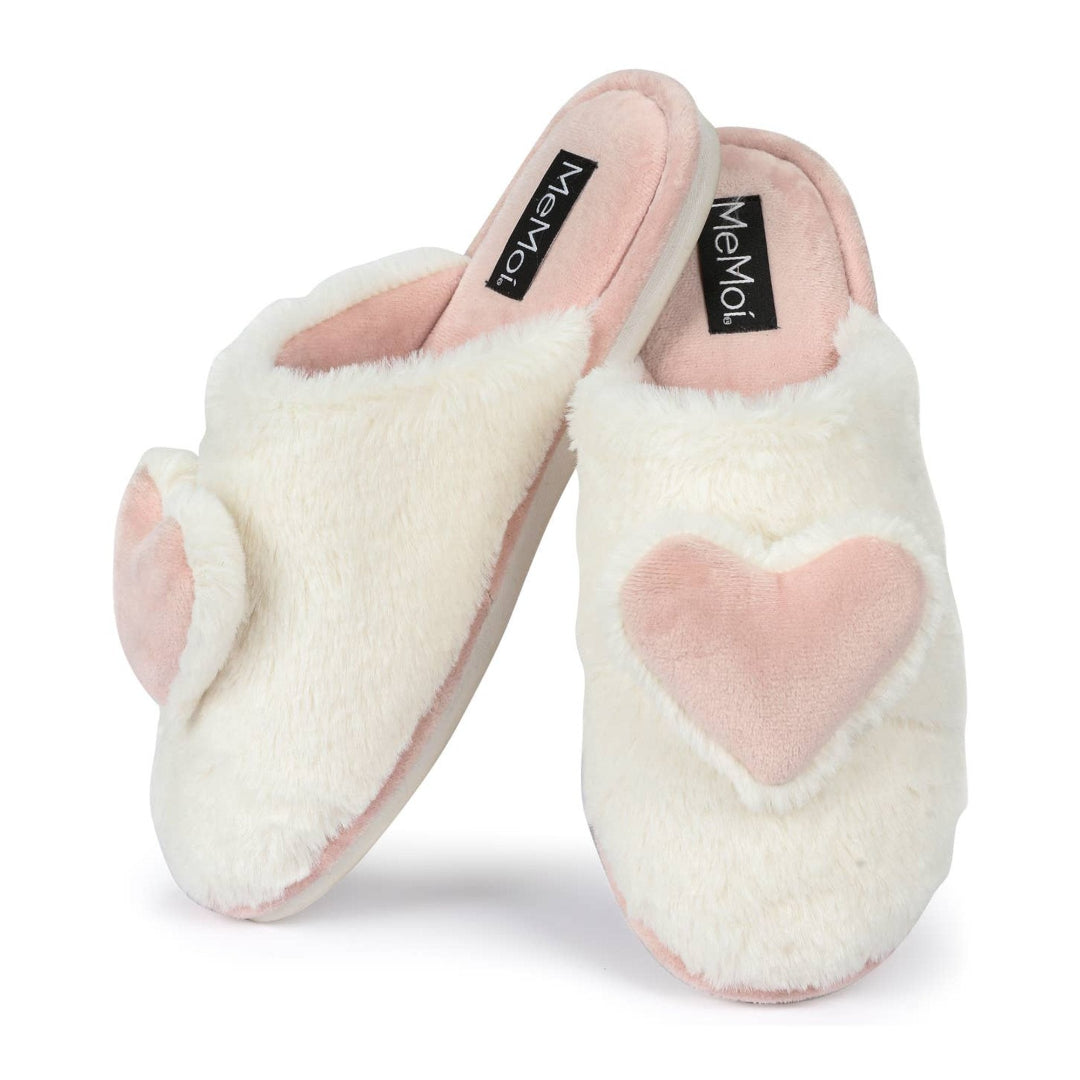 Pair of white slippers with pink hearts on a white background