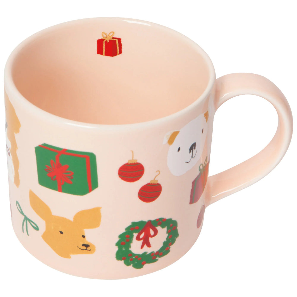 Pink mug with Christmas-themed illustrations on a white background