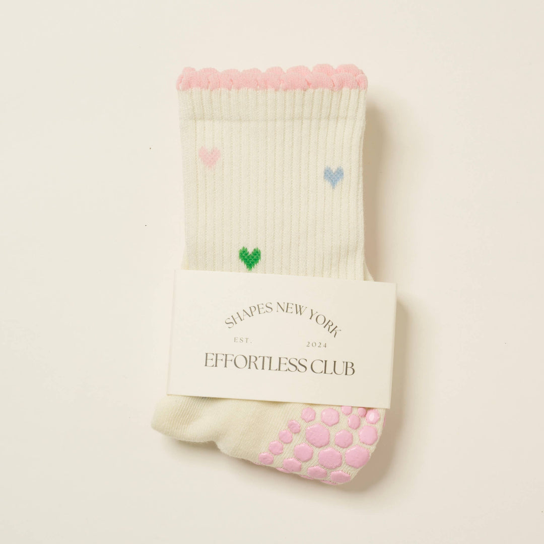 Pair of socks with hearts designs on a beige background