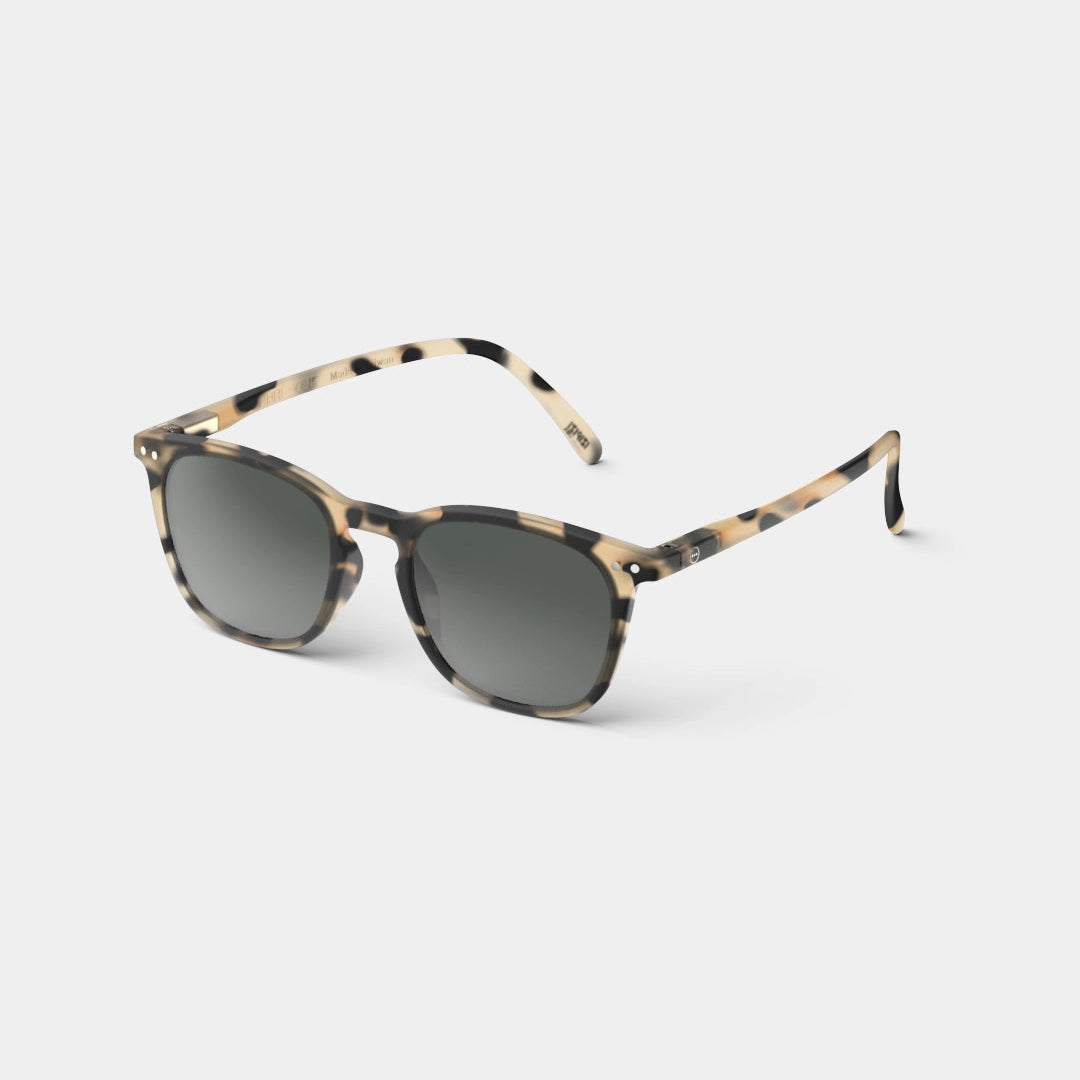A pair of round-framed sunglasses with a light tortoise pattern, featuring flexible arms and a rubber texture for comfort.