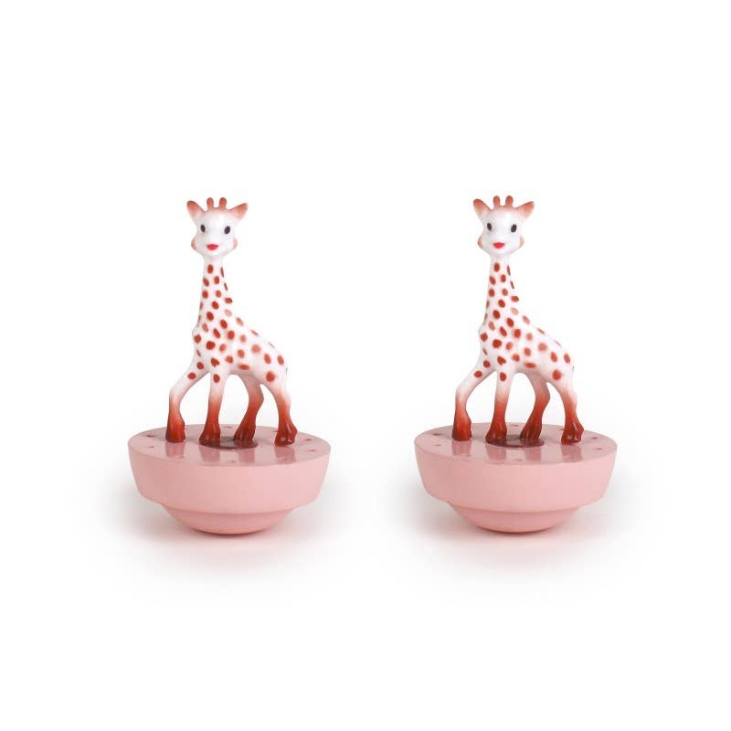 Two giraffe figurines on pink bases against a white background
