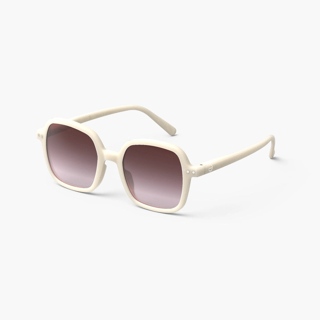 A pair of oversized square sunglasses with a vintage cream color frame and cream-colored lenses.