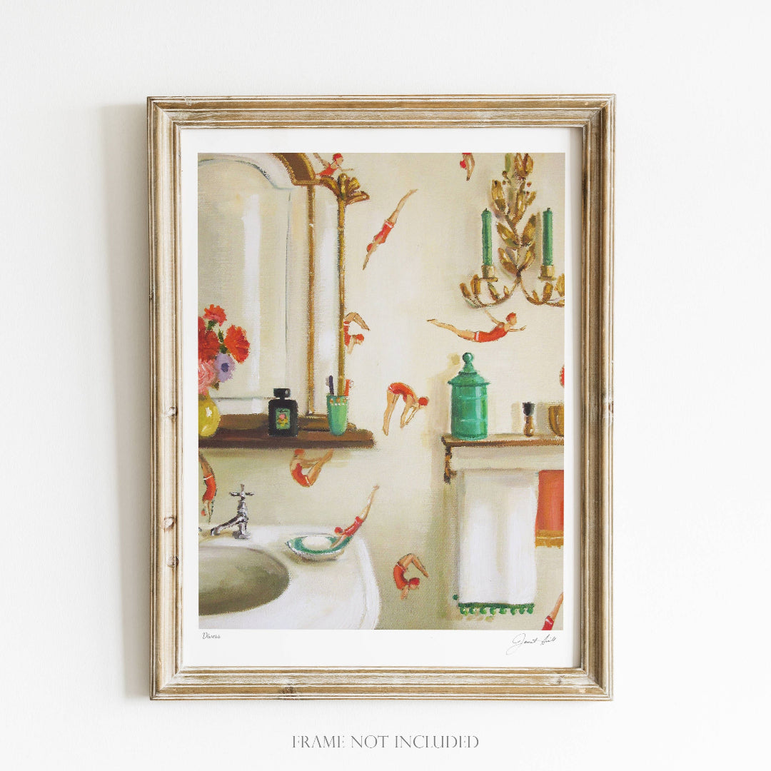 A framed art print featuring a classical underwater scene with divers, displayed in a home decor setting. The frame is wooden and the artwork is signed by 'Janet Hill Studio'.