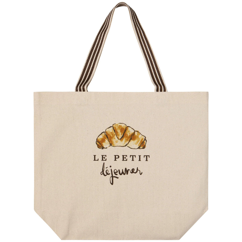 Beige tote bag with a croissant illustration and 'Le Petit Dejeuner' text on a white background