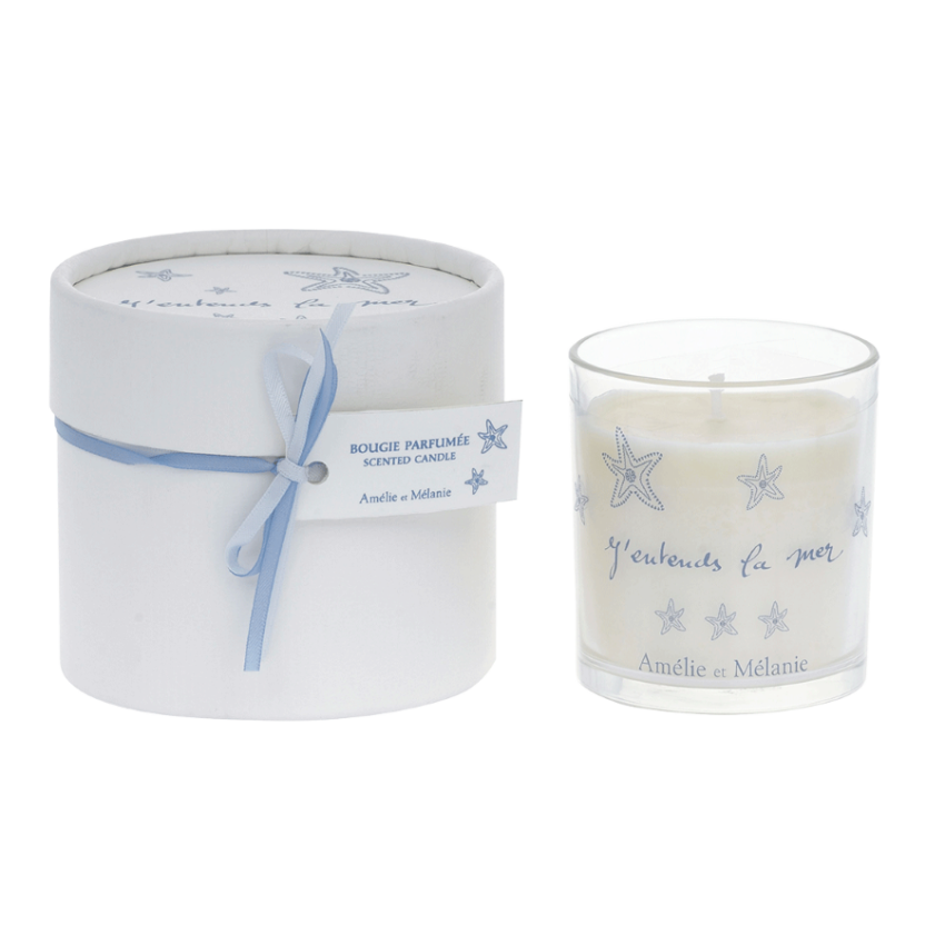 Candle in a round box with a blue ribbon on a white background