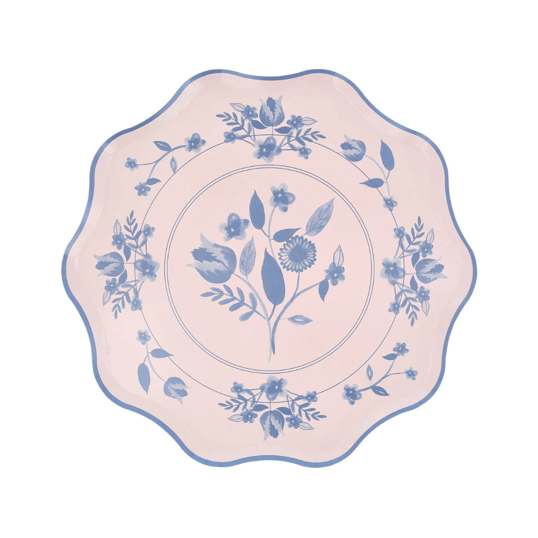 Decorative plate with blue floral pattern on a pink background