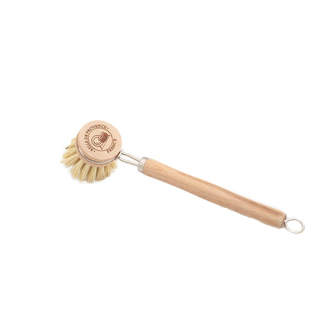 A dish brush with a wooden handle and beige bristles arranged in a circular pattern at the end.