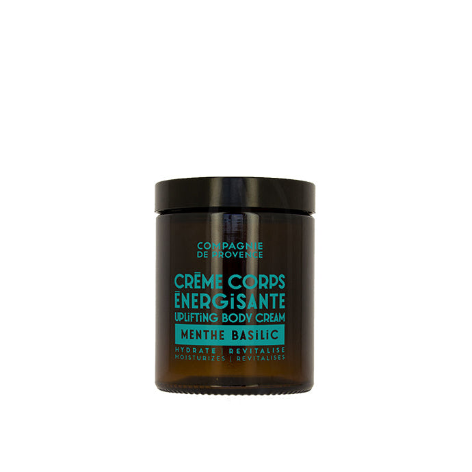 A jar of body cream with a label indicating it is an 'Energizing Body Cream' with mint and basil scents.