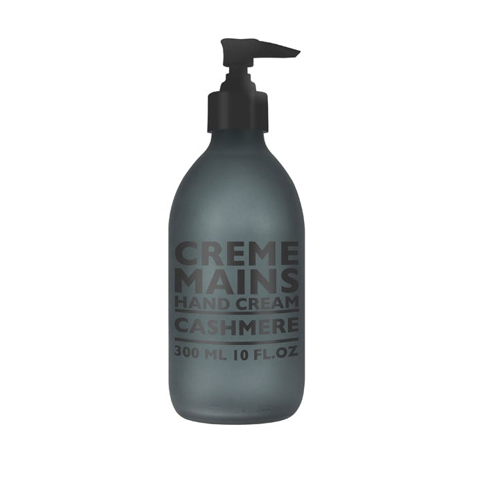 A frosted glass bottle with a black pump dispenser labeled 'CREME MAINS CASHMERE 300ml' containing hand cream.