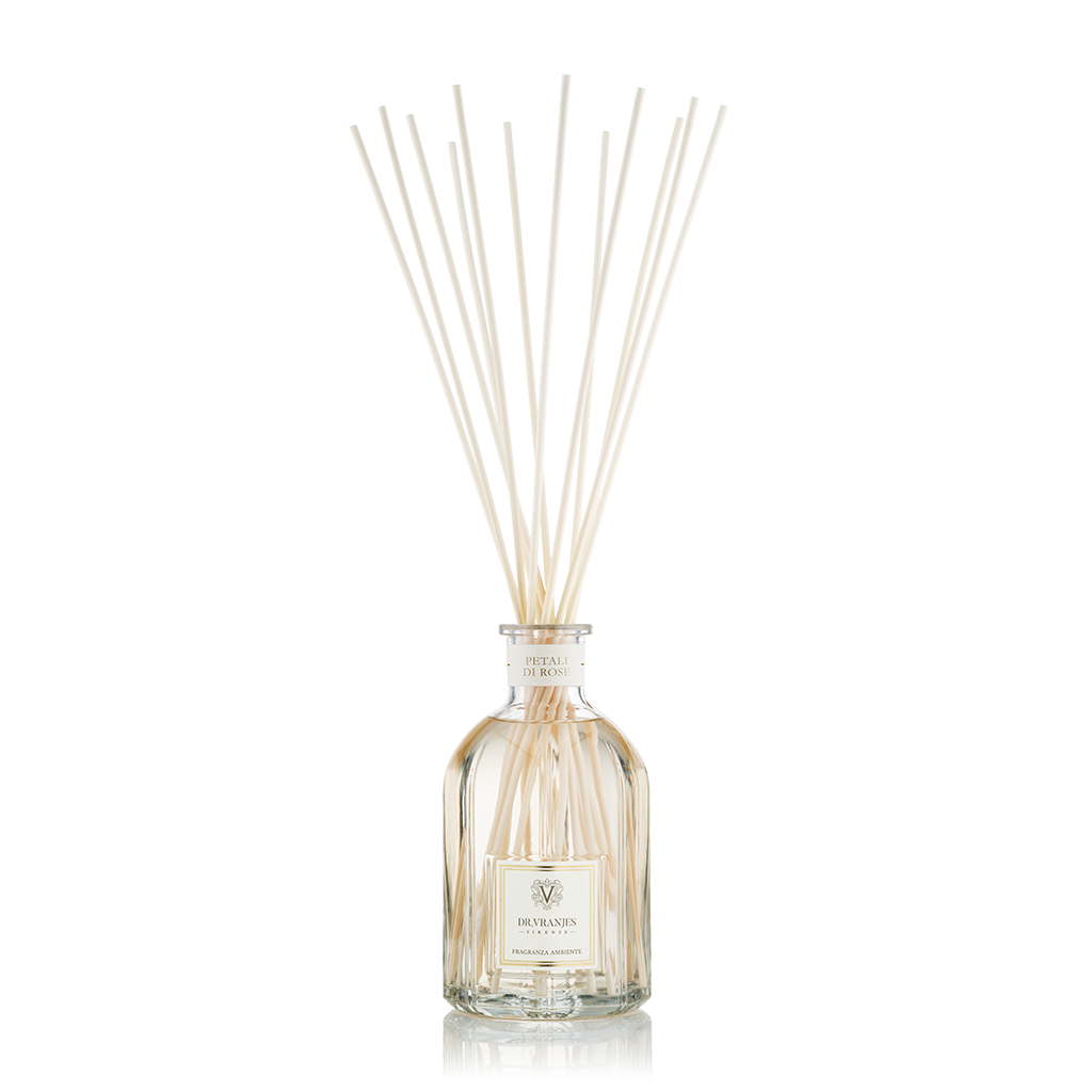 A clear glass diffuser bottle with several white sticks inserted, representing the Petali di Rose fragrance.