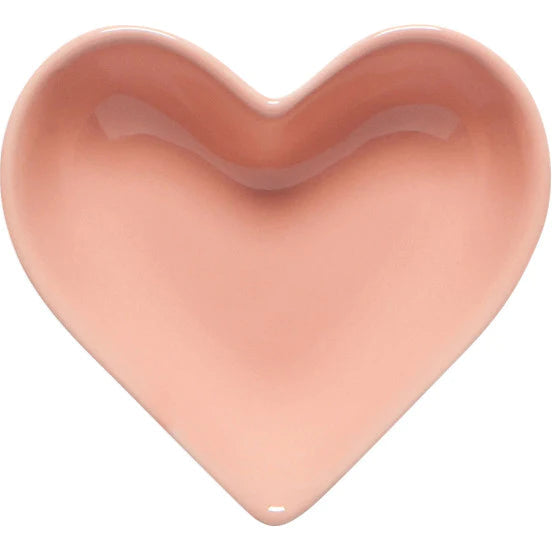 Heart-shaped object in a soft pink color on a white background