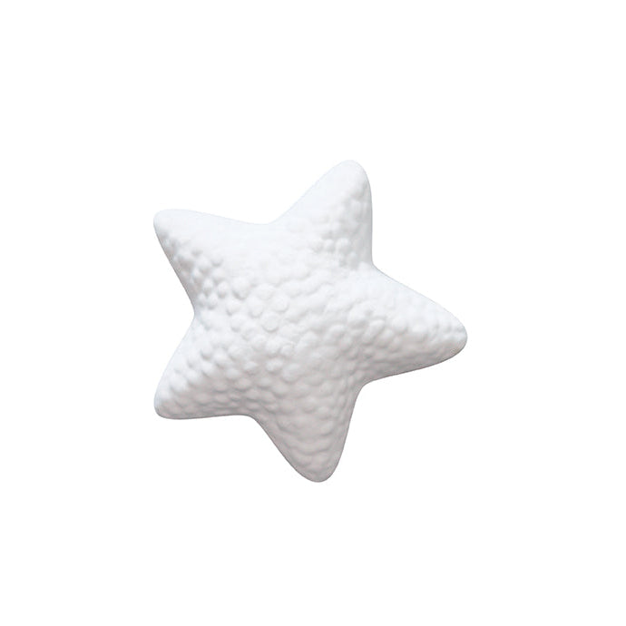 A white star-shaped bar of soap against a plain background.