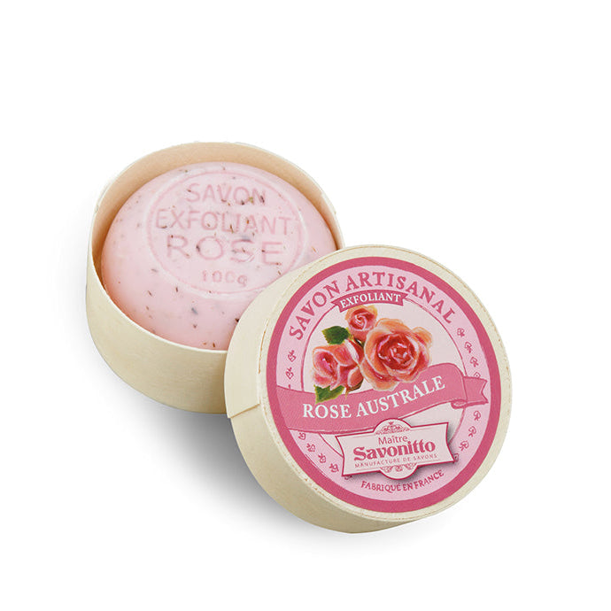 Pink soap bar in a round container with a decorative lid on a white background