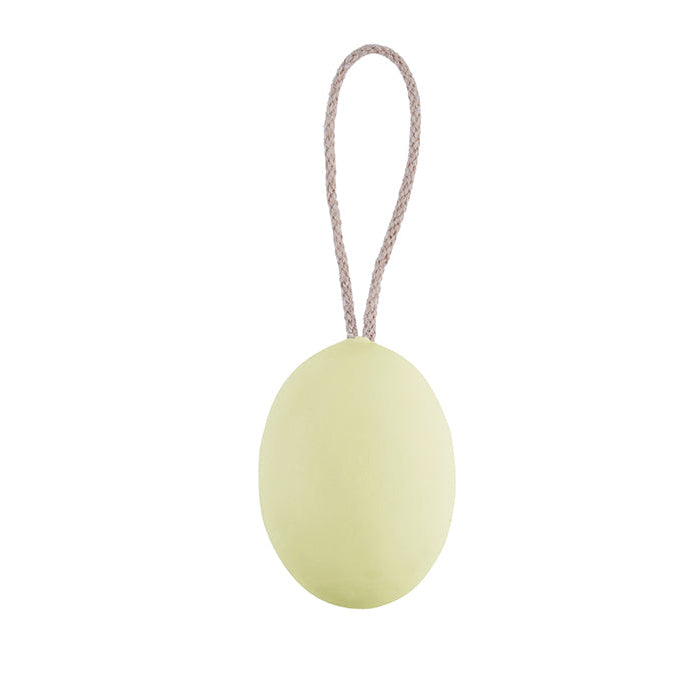 A green oval-shaped soap on a rope against a white background