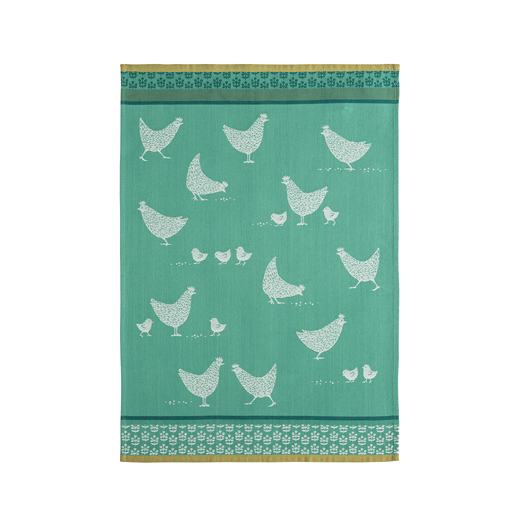 A green cotton tea towel with white chicken patterns and a decorative border.