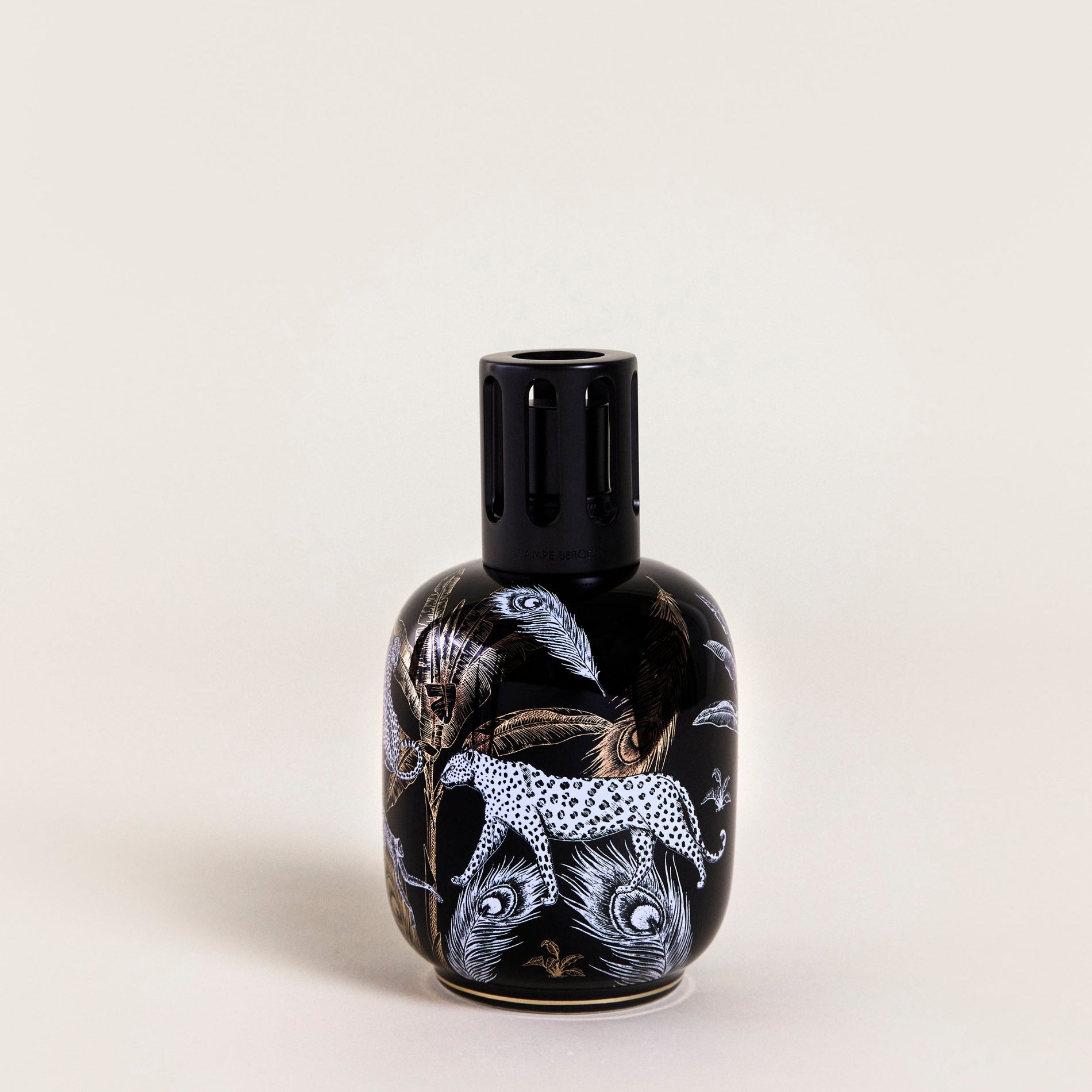 Black vase with animal designs on a beige background