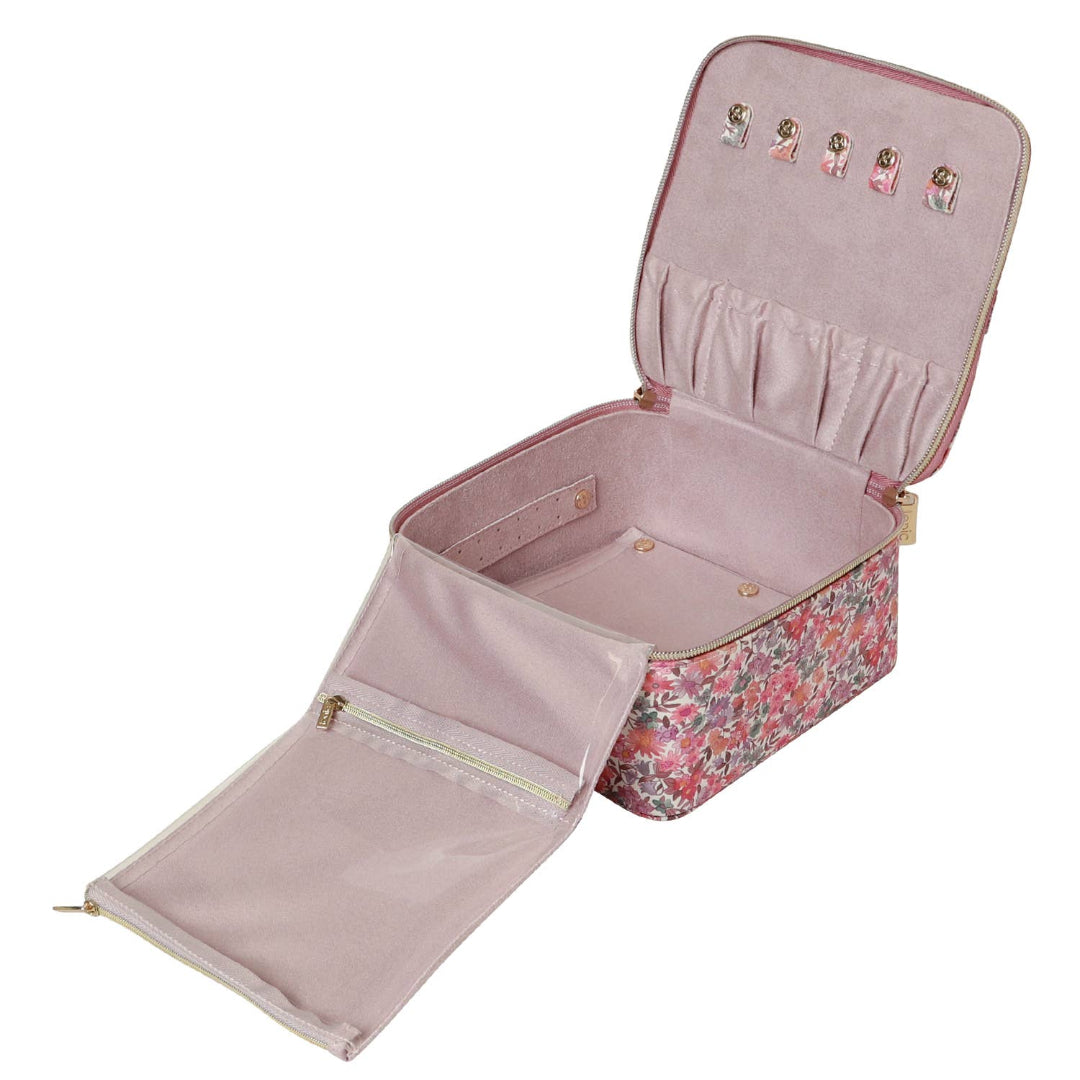 Pink jewelry case with floral pattern and open lid on a white background