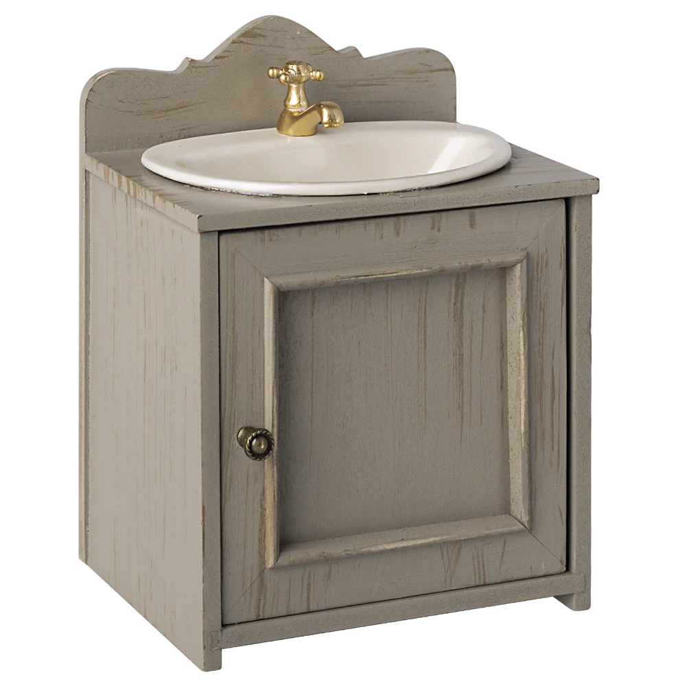 Wooden vanity with sink and gold faucet on a white background