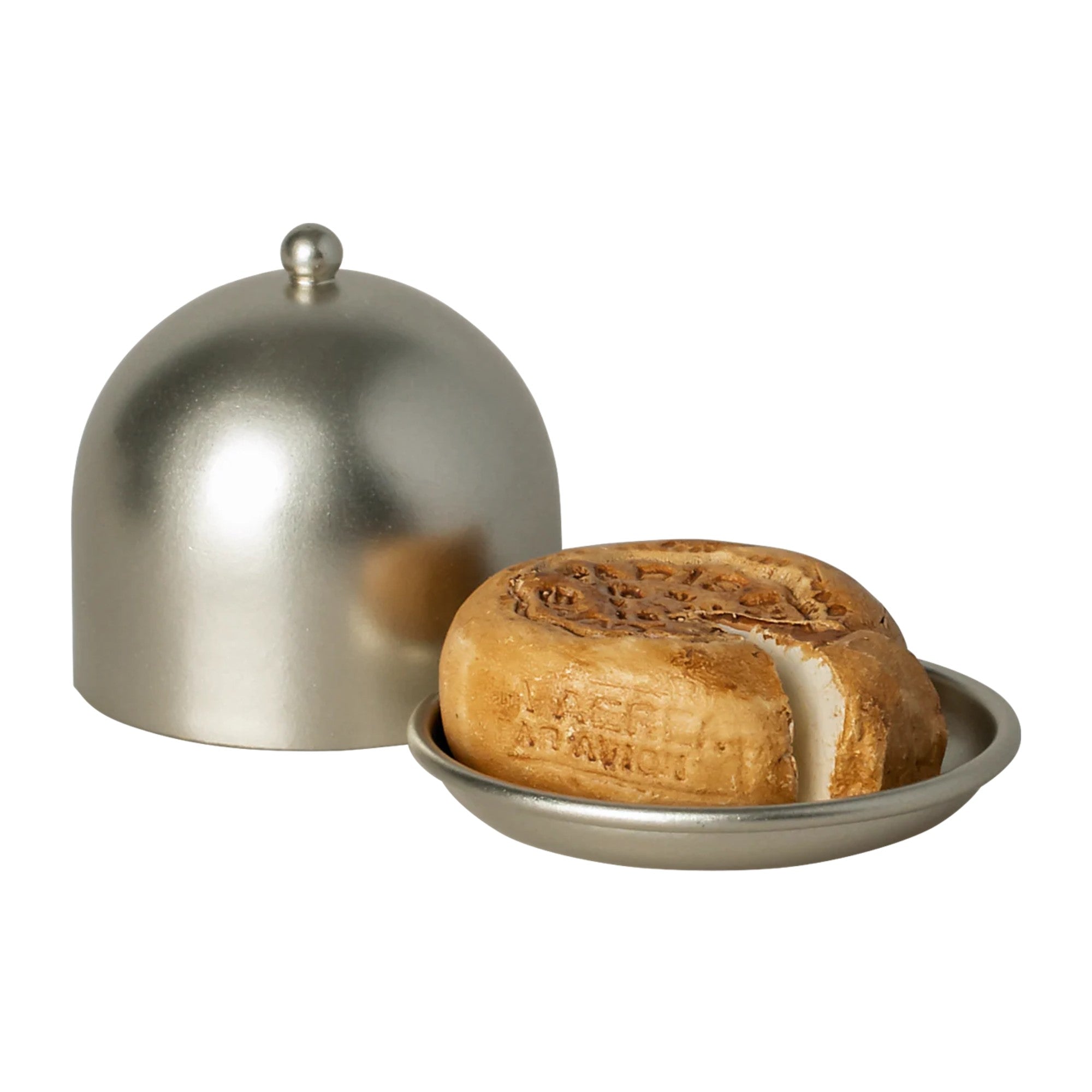 Cheese wheel with a metal dome cover on a white background