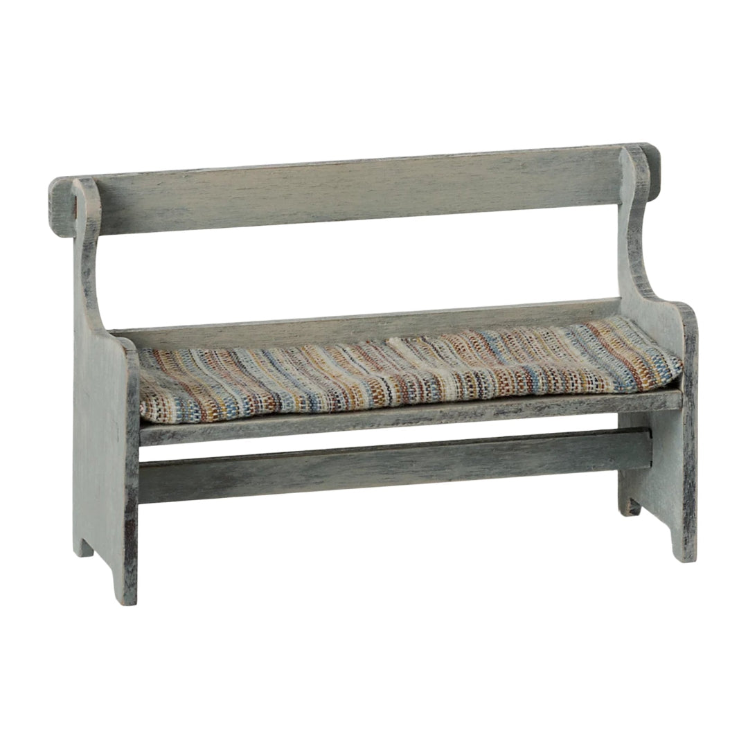 Wooden bench with a striped cushion on a white background