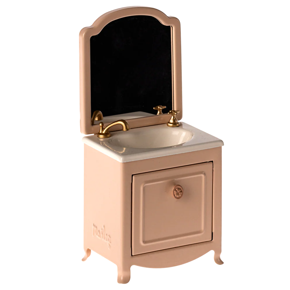 Small vanity with mirror and sink on a white background