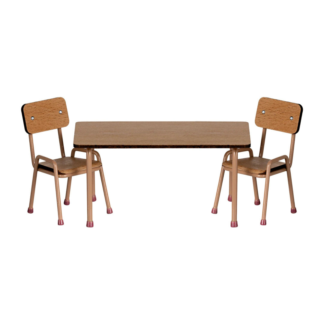 Wooden table with two matching chairs on a white background