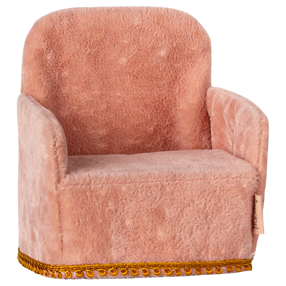 A pink upholstered folding chair toy designed for small children, with a gold trim at the bottom.