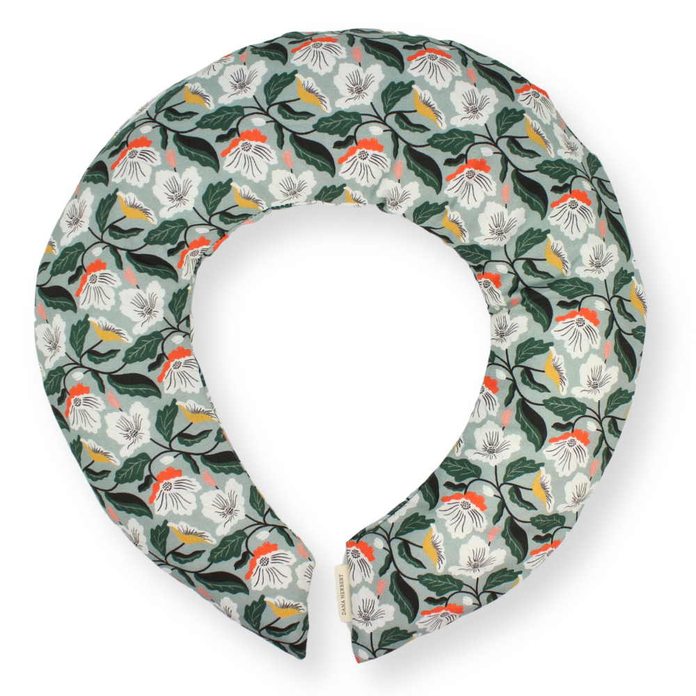 Floral patterned neck pillow on a white background